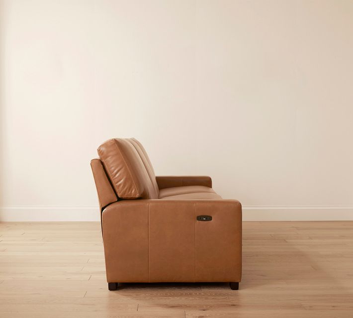 Side view of brown leather sofa showing mechanism at base