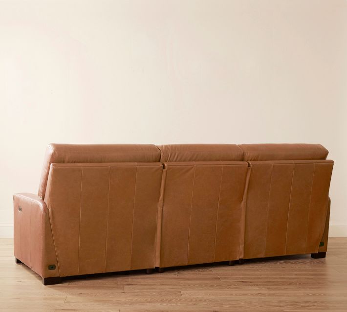 Rear view of a brown leather sofa showing back cushions