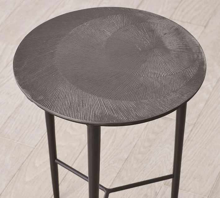 Top view of round textured table top on a metal stand