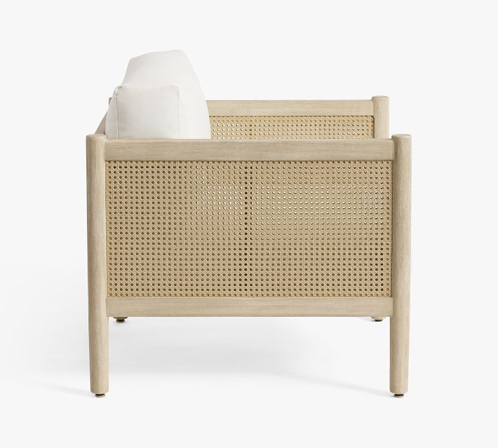 Back view of a single chair with cane panels on sides.