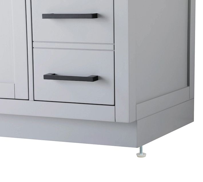 Base of a light gray bathroom vanity showing the plinth and adjustable leveling leg.