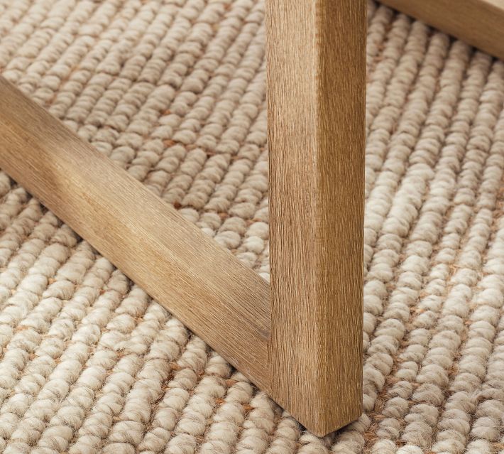 Front leg and support frame of the chair on a woven rug