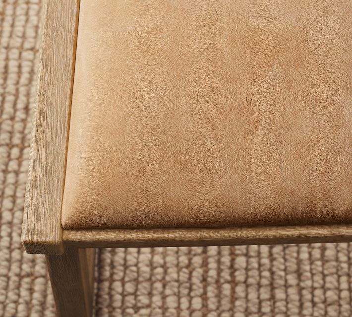 Close-up of the chair backrest upholstered in tan leather