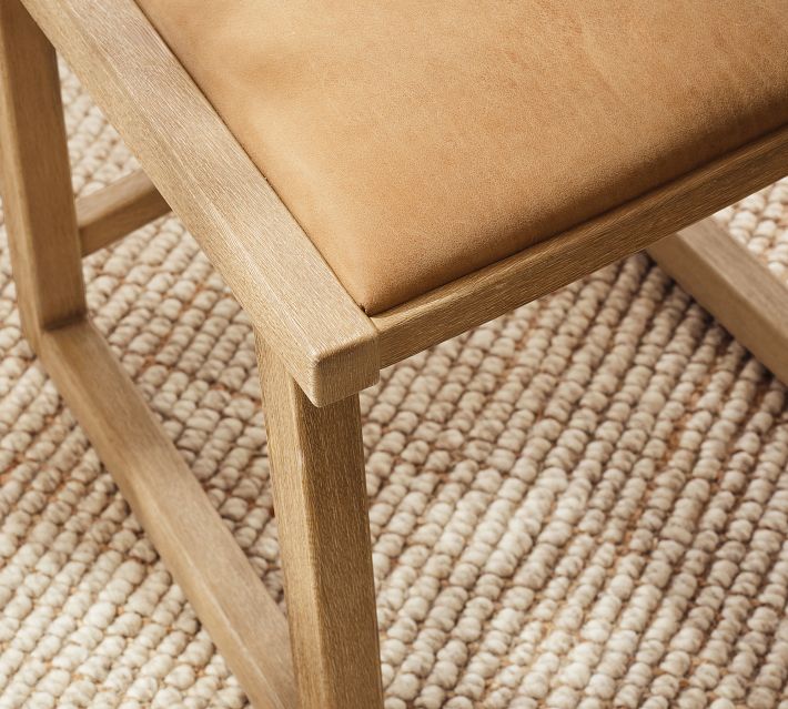 Close-up of chair leg joint and light wood grain