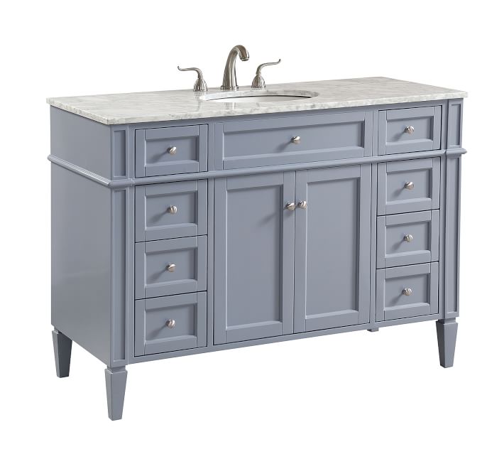 Grey-blue bathroom vanity with marble top, showing drawers and central cabinet doors.