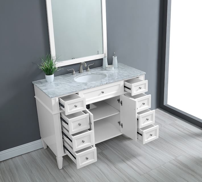 Close-up of bathroom vanity drawer open showing interior storage and drawer slides.
