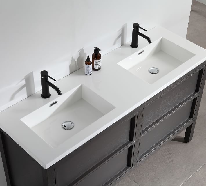 Double sink vanity with countertop items and open storage drawers showing organized supplies.