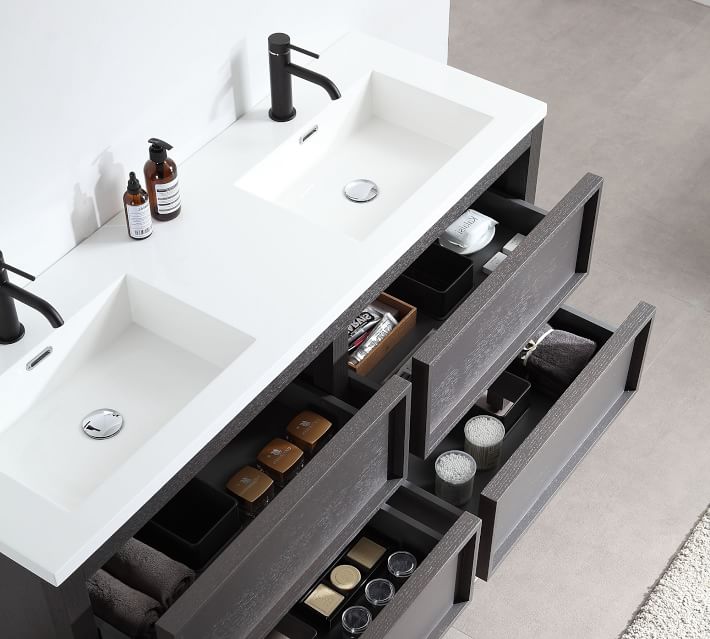 Top view of double sink vanity with open drawers showing hair care and makeup items.