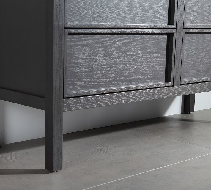 Close-up of lower drawer and frame showing wood texture.
