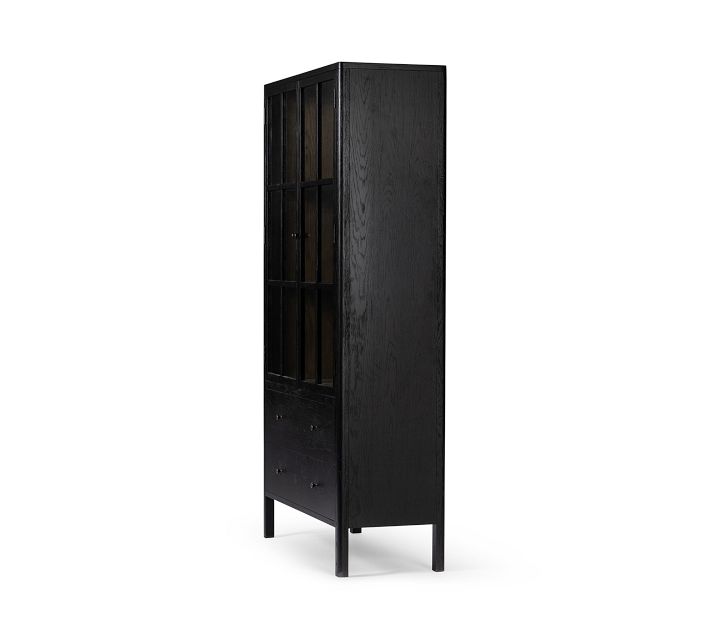 Side view of a tall black cabinet with visible wood grain and slim legs.