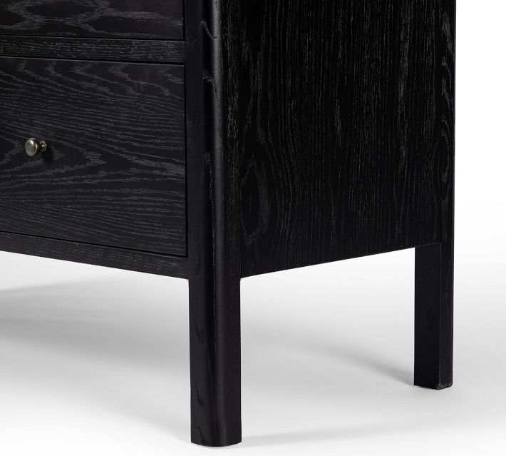 Lower leg of cabinet with black finish and wood grain, standing on a white background.