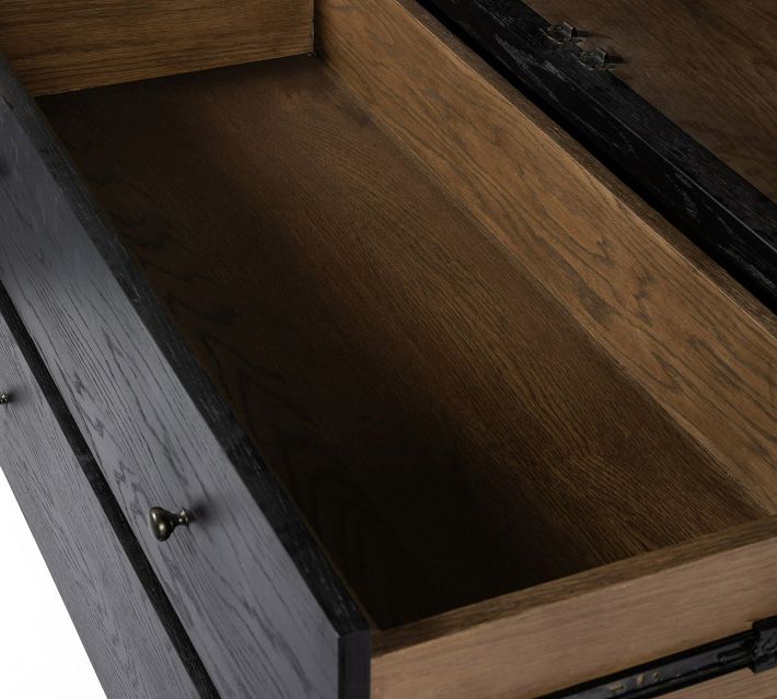 Interior corner of drawer sliding mechanism inside cabinet.