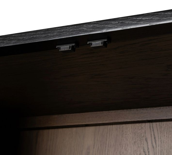 Close-up of underside of the top panel with small metal brackets or hinges.