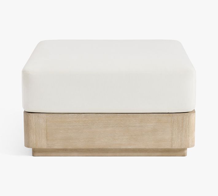 Close-up of cushioned ottoman base with white cushion on light wood frame