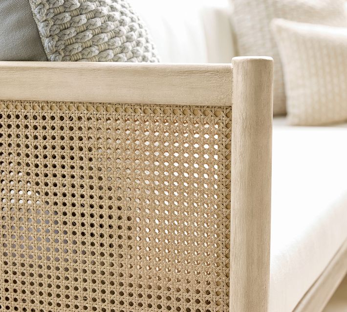 Close-up of woven cane panel on the side of the sofa frame