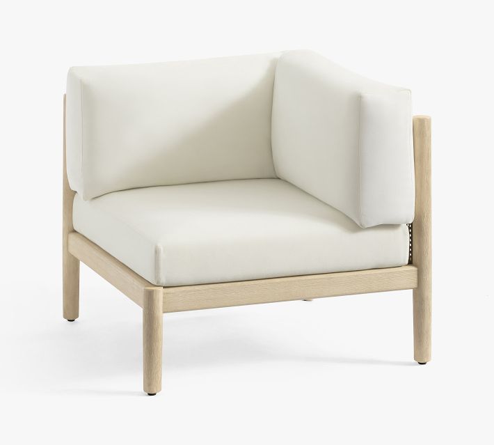 Corner view of white cushioned seating in modular sofa with wooden frame