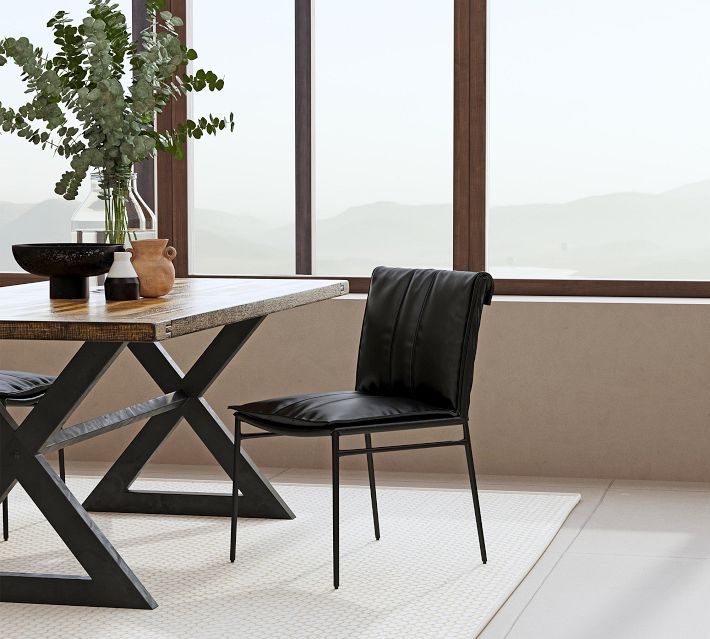 Dining room set with black leather chairs around a wooden table, modern design