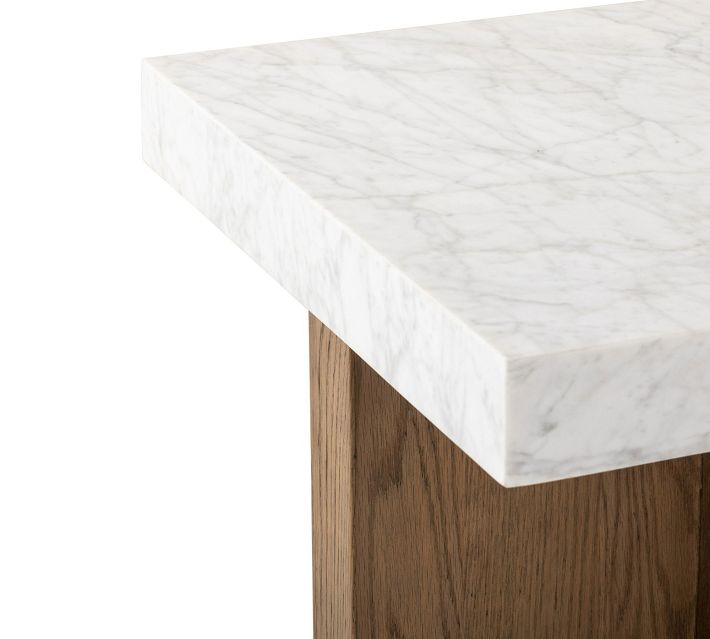Close corner of marble tabletop and wooden leg