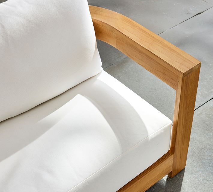 White sofa cushions with wooden frame edge detail