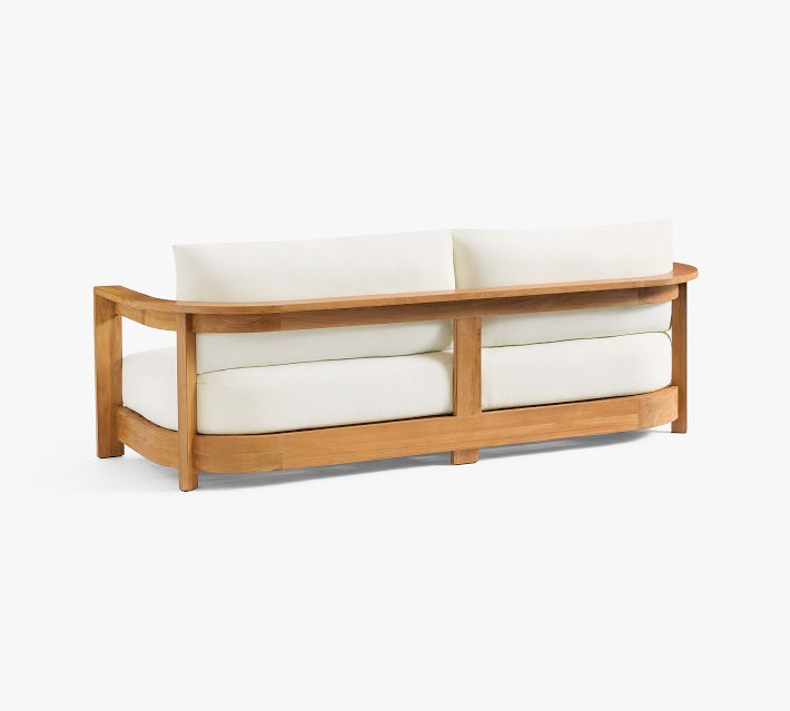 Back view of white cushioned sofa with wooden frame