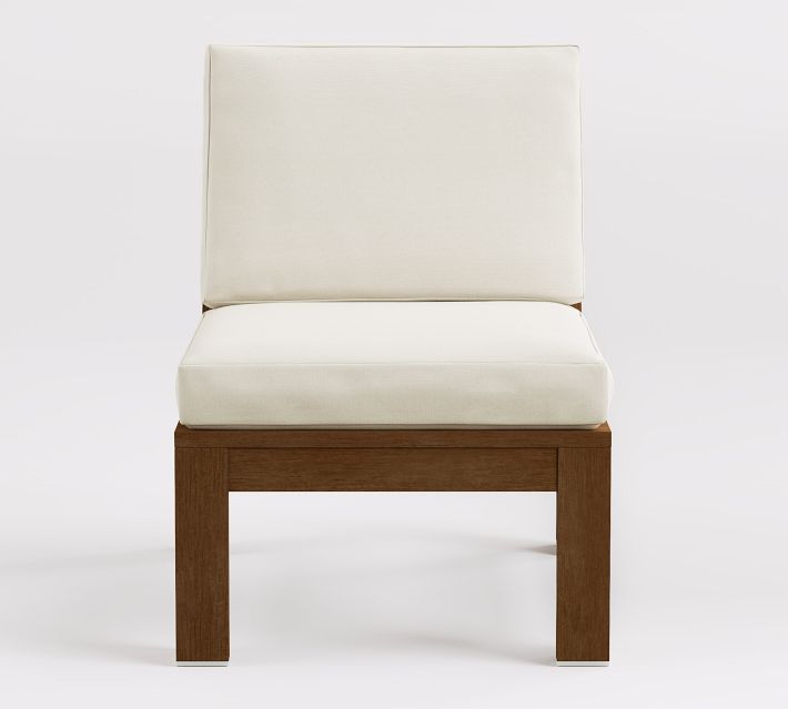 Single armless chair with cream cushion and wooden frame