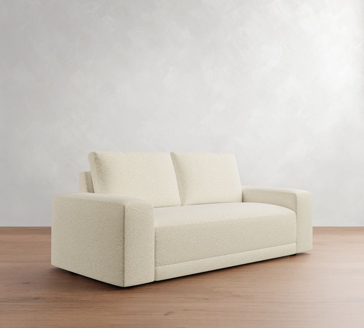 Three-quarter view of a beige loveseat with two back cushions