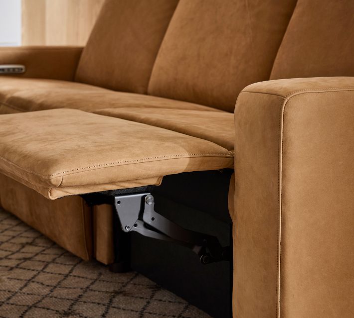 Detail shot of reclining mechanism and metal hinge under the sofa seat.