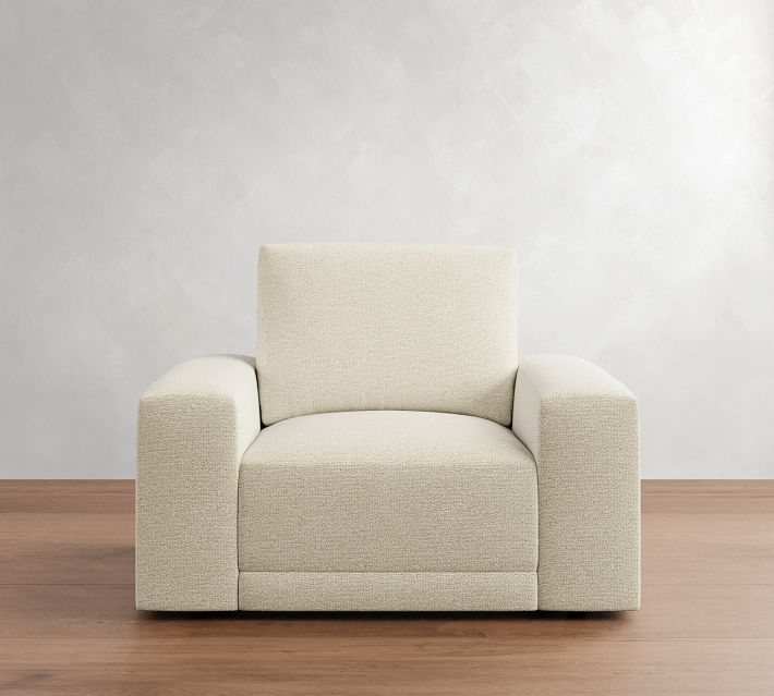 Front view of a cream-colored upholstered armchair with thick armrests