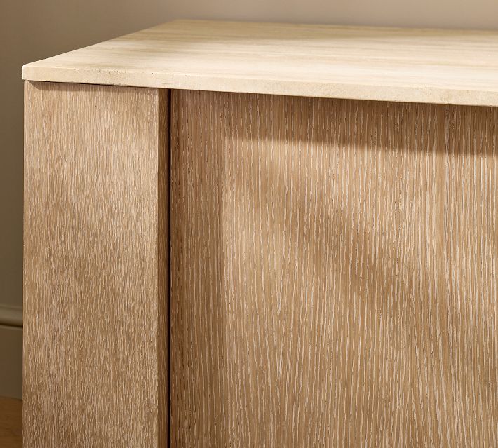 Close-up of the top edge of the wooden cabinet showing its light wood grain