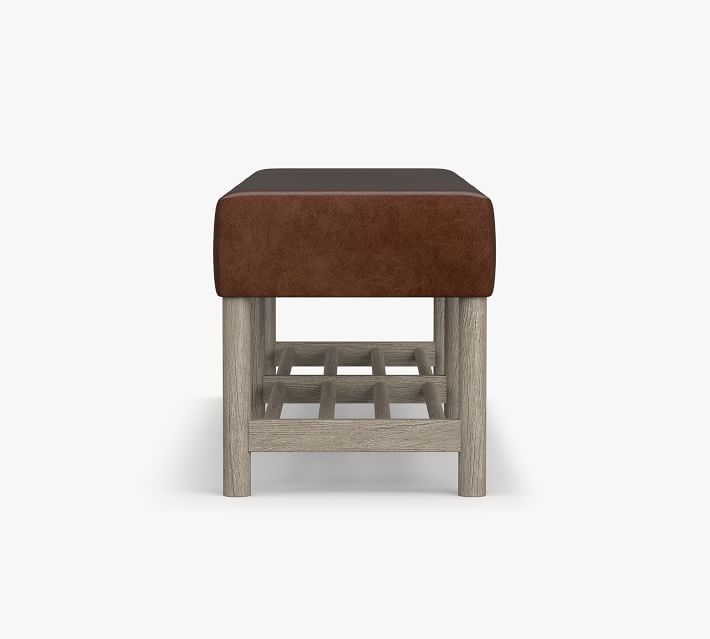 Close-up of the bench showing leather seat and wooden legs from front view.