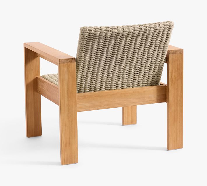 Back view of beige woven armchair with wooden frame on white background