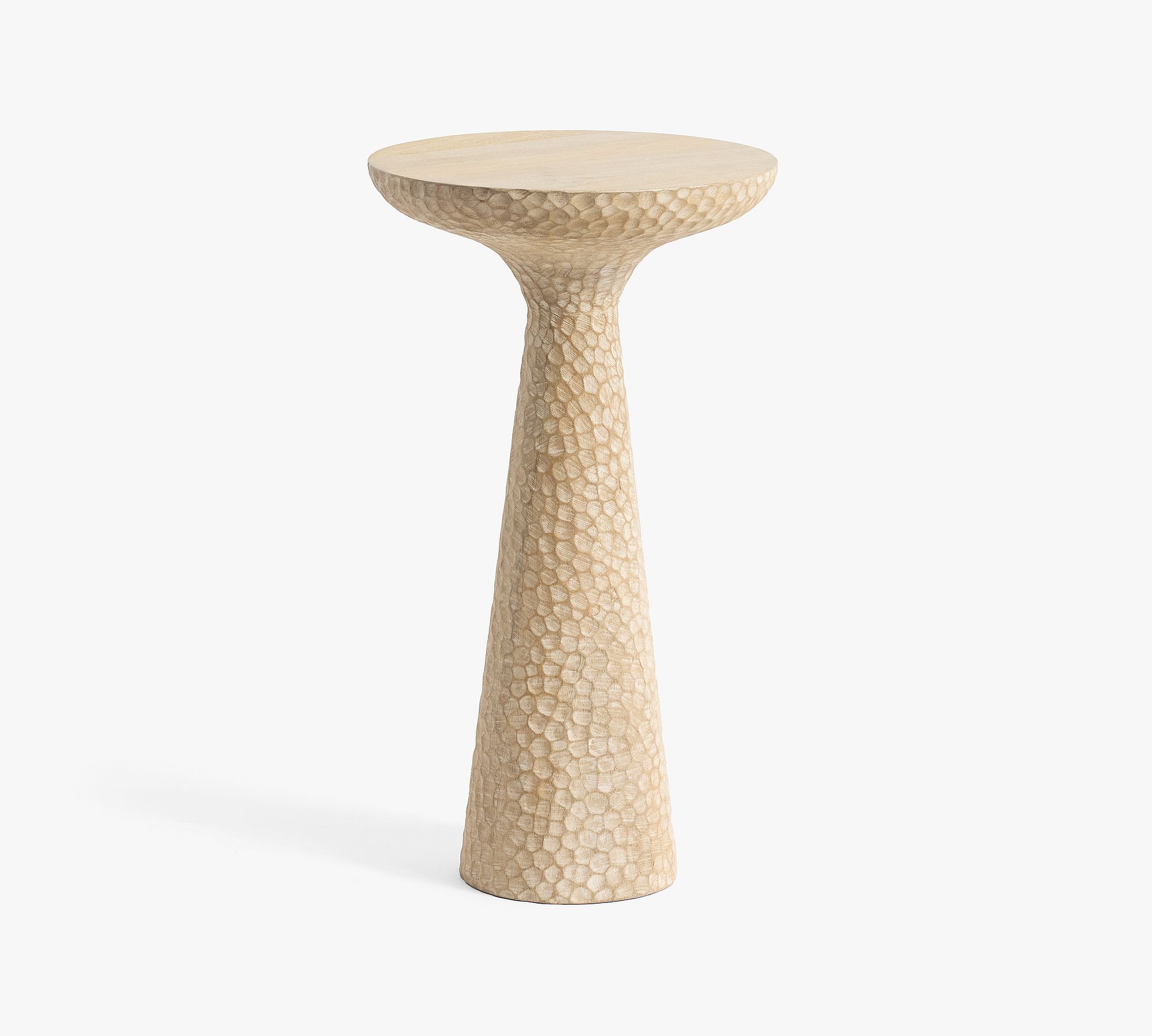 Close-up of carved round accent table showing hexagonal carved texture