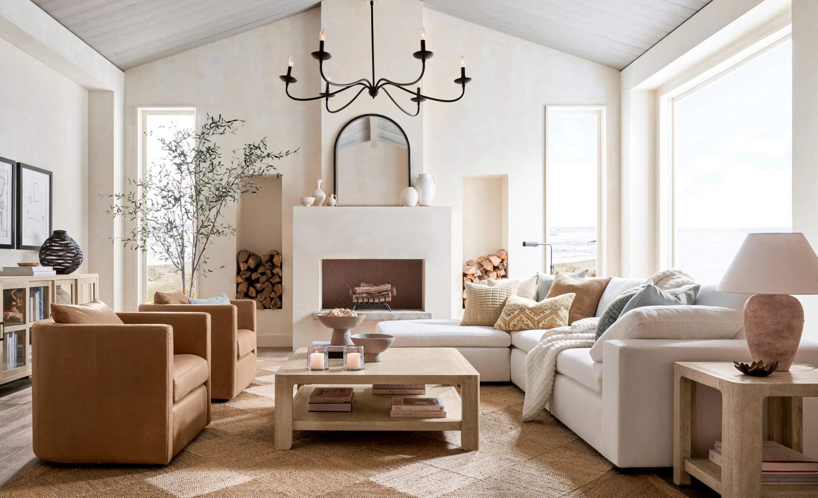 Bright, airy living room with a neutral color palette featuring a white sectional sofa with pastel throw pillows.