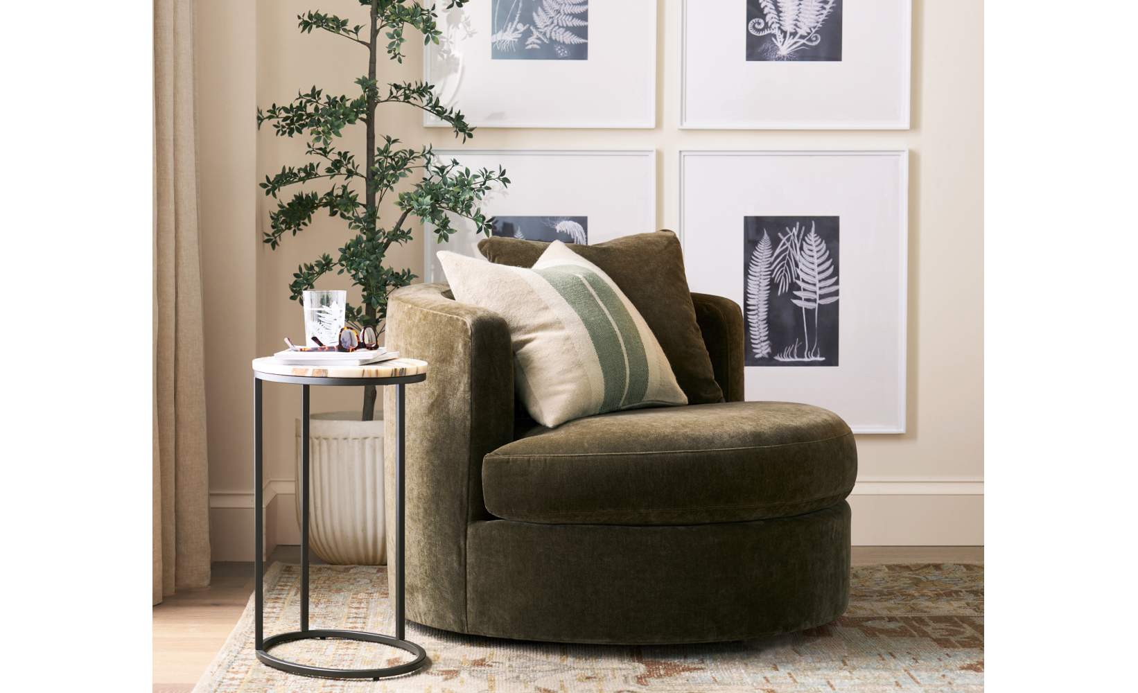 Modern reading nook with olive green velvet swivel chair, black metal C-table, and cream striped throw pillows on vintage-inspired patterned area rug, creating a cozy corner aesthetic. Modern reading nook with olive green velvet swivel chair, black metal C-table, and cream striped throw pillows on vintage-inspired patterned area rug, creating a cozy corner aesthetic.