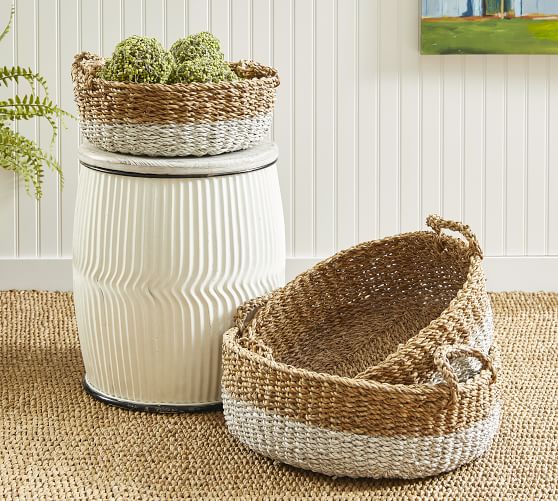 Close-up of lidded wicker storage boxes on bamboo stool Stock