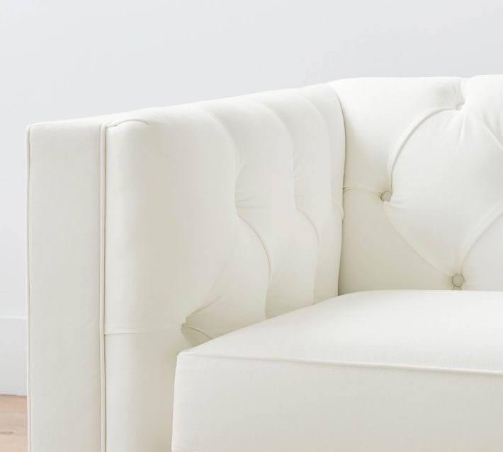 Close-up tufted white upholstery with button indentations
