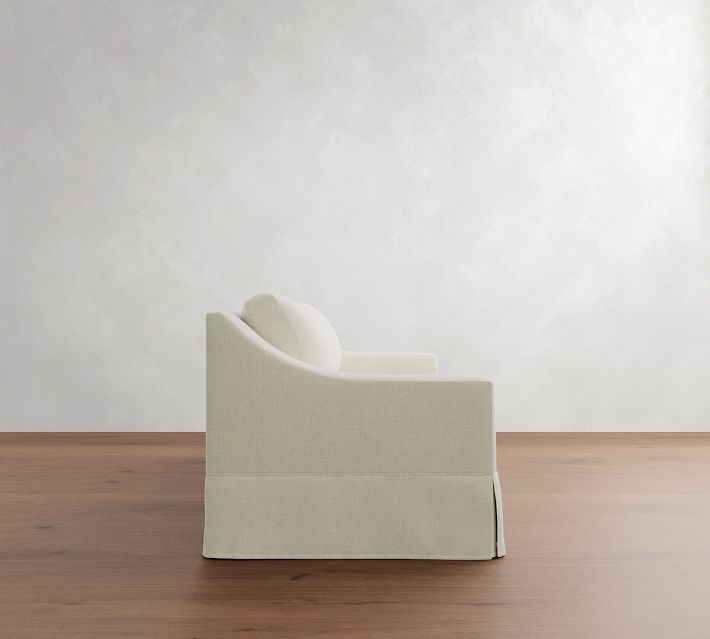 Close side view of the white sofa showing its arm and back corner.