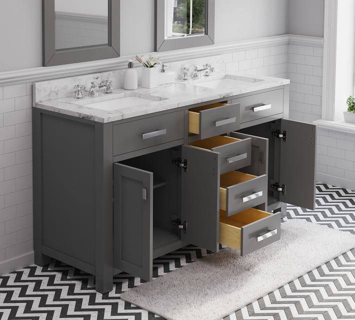 Open drawers and cabinets showing interior storage in a gray bathroom vanity with marble countertop.