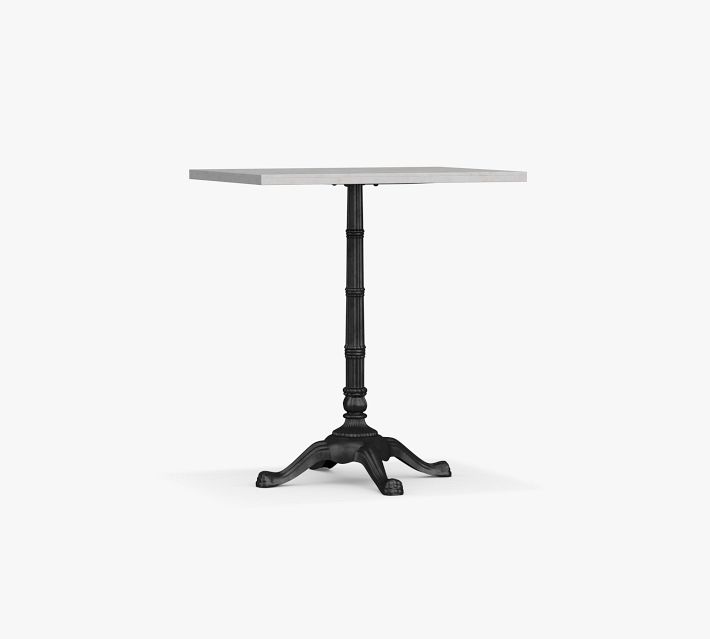 Tall pedestal table with a light wood top and a black ornate pedestal base on a white background.