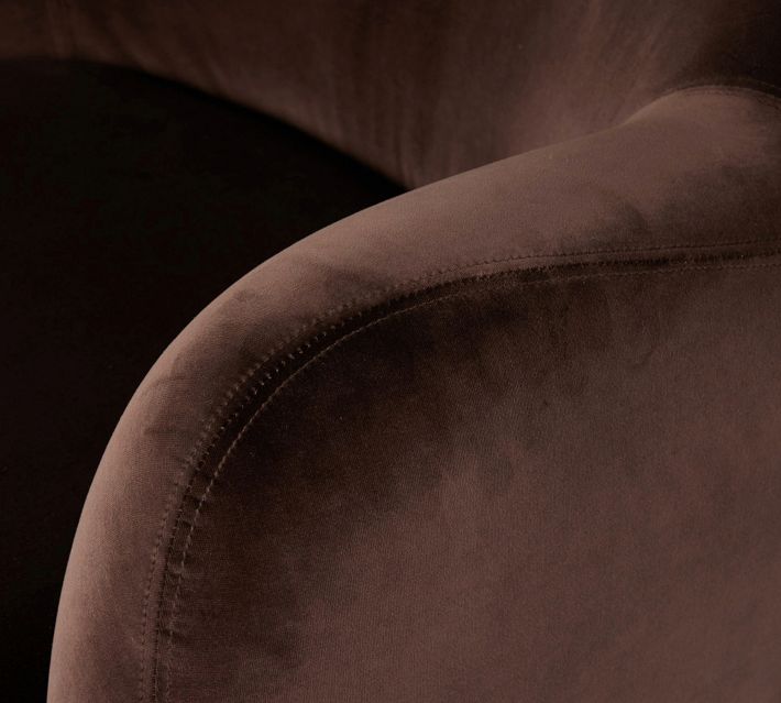 Close-up of armrest stitching on brown velvet chair