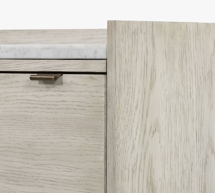 Close-up of the right edge of a dresser showing a drawer with a brass handle