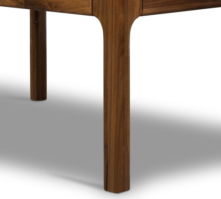 Close-up of leg and corner joint of wooden dresser, showing curved leg connection.