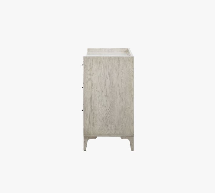 Narrow side view of single cabinet piece from dresser showing top opening