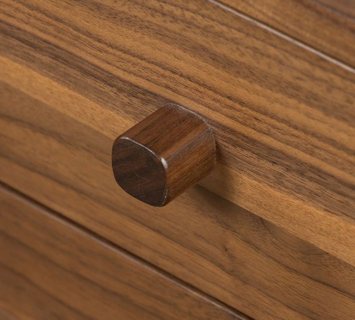 Round wooden knob close-up on drawer front.