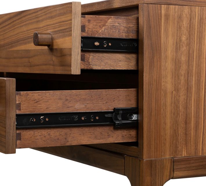 Open drawers with metal slides inside cabinet, showing internal hardware.