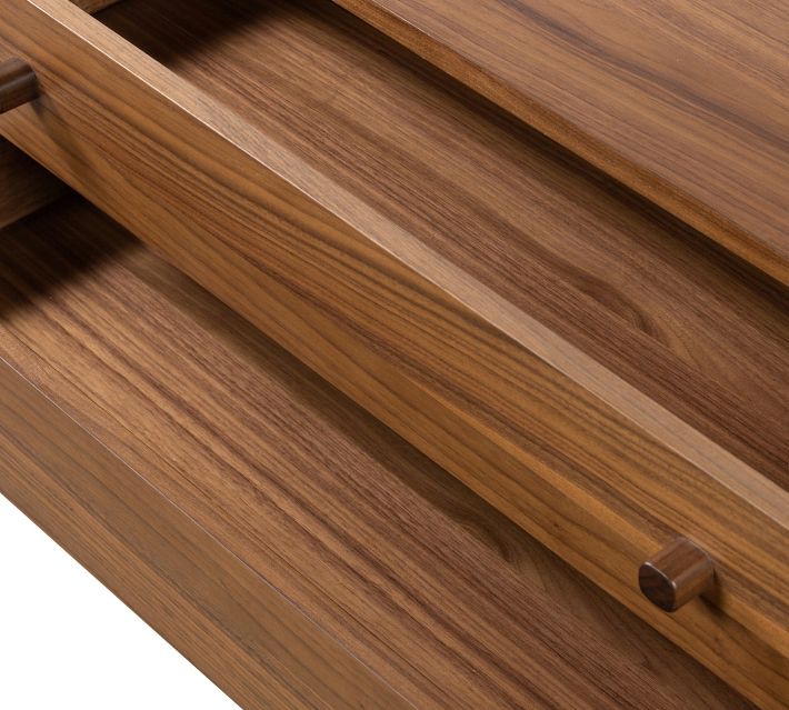 Close-up of drawer side showing wooden dowel joints and dovetail connection.