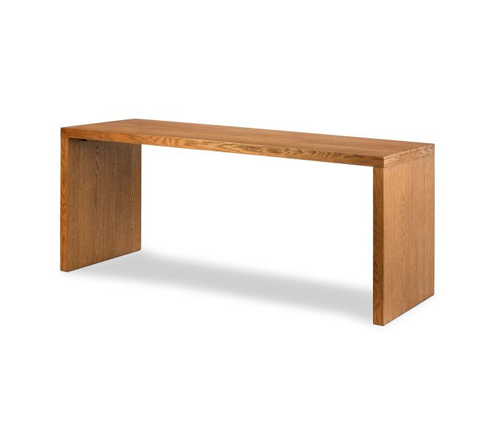 Desk with integrated cabinet drawers and legs, wooden finish.