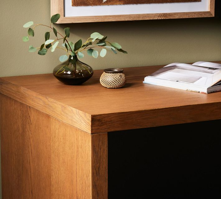 Close-up of the desk edge and corner with wood grain.