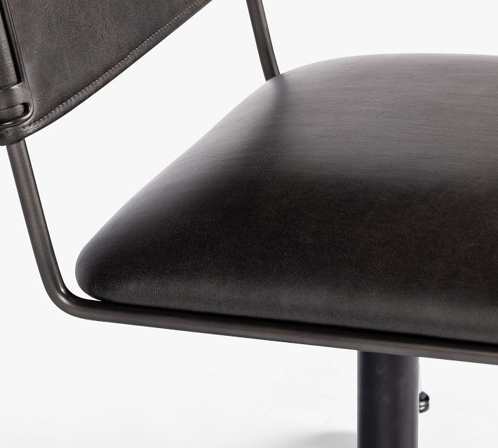 Seat cushion of the chair showing dark brown leather surface