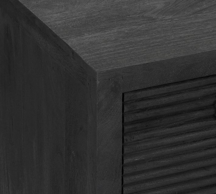 Close-up of cabinet edge and ribbed drawer front